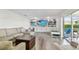 Bright living room featuring a cozy sofa, custom built-ins, and a view of the backyard at 10387 Majestic Dr, Largo, FL 33774