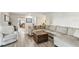 Inviting living room with a sectional sofa, a recliner, and modern wood-look flooring at 10387 Majestic Dr, Largo, FL 33774