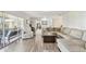 Spacious living room with plenty of seating, modern floors, and access to the patio at 10387 Majestic Dr, Largo, FL 33774