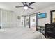 Bedroom with a ceiling fan, closet, sliding door access to the patio, and built-in shelving unit at 10387 Majestic Dr, Largo, FL 33774