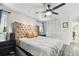 Bedroom featuring neutral walls, a ceiling fan, a walk-in closet, and decorative curtains framing the window at 10387 Majestic Dr, Largo, FL 33774