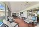 Inviting screened patio with ceiling fans, cozy seating, and plenty of room to relax at 10387 Majestic Dr, Largo, FL 33774