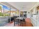 Spacious screened patio with outdoor dining, barbeque area and seating with backyard views at 10387 Majestic Dr, Largo, FL 33774