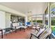 Inviting screened patio with comfortable seating and tile flooring, great for entertaining at 10387 Majestic Dr, Largo, FL 33774