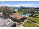Aerial view of community pool and clubhouse, surrounded by lush landscaping and inviting recreational spaces at 10387 Majestic Dr, Largo, FL 33774
