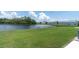 Expansive lawn space leading to the pond, perfect for outdoor relaxation and activities at 11617 Colony Lake Dr, Tampa, FL 33635