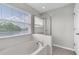 Bright bathroom featuring a soaking tub, glass shower, and a window with a lake view at 11617 Colony Lake Dr, Tampa, FL 33635