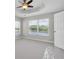 Bright bedroom features a tray ceiling, ceiling fan, and a window overlooking the lake at 11617 Colony Lake Dr, Tampa, FL 33635