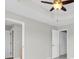 Neutral bedroom with multiple closet doors, updated ceiling fan, and fresh paint at 11617 Colony Lake Dr, Tampa, FL 33635