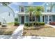 Inviting blue townhome with manicured landscaping and a paved walkway leading to the entrance at 11617 Colony Lake Dr, Tampa, FL 33635
