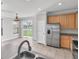 Kitchen with stainless steel refrigerator and a view of the adjacent dining area and outdoor scenery at 11617 Colony Lake Dr, Tampa, FL 33635