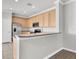 Modern kitchen featuring stainless steel appliances, wood cabinets, and a breakfast bar at 11617 Colony Lake Dr, Tampa, FL 33635
