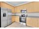 A modern kitchen featuring stainless steel appliances, tile flooring, and ample cabinet storage space at 11617 Colony Lake Dr, Tampa, FL 33635