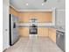 Bright kitchen features stainless steel appliances and light wood cabinetry providing ample storage space at 11617 Colony Lake Dr, Tampa, FL 33635