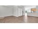 Open-concept living room with wood floors and white walls, leading to the kitchen and stairway at 11617 Colony Lake Dr, Tampa, FL 33635