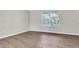Sunny living room with wood floors, a big window looking out to the palm trees at 11617 Colony Lake Dr, Tampa, FL 33635
