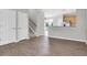 Open living area with wood floors, staircase, and a view of the kitchen and backyard at 11617 Colony Lake Dr, Tampa, FL 33635