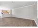 Spacious, bright living room with wood floors, neutral walls, and an open view to the kitchen at 11617 Colony Lake Dr, Tampa, FL 33635