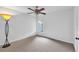 Carpeted bedroom with ceiling fan, window for natural light, and closet space at 11816 Cedarfield Dr, Riverview, FL 33579