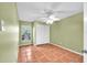 Charming bedroom featuring tile floors, ceiling fan, a closet, and a window at 11816 Cedarfield Dr, Riverview, FL 33579