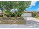 Charming single-story home featuring a two-car garage and mature landscaping at 11816 Cedarfield Dr, Riverview, FL 33579