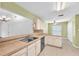 Bright kitchen with tile countertops and stainless steel appliances at 11816 Cedarfield Dr, Riverview, FL 33579