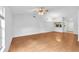 Bright living room featuring wood floors, ceiling fan, and easy access to the kitchen at 11816 Cedarfield Dr, Riverview, FL 33579