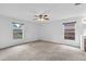 Spacious main bedroom featuring neutral carpet, ceiling fan, and windows offering natural light at 11816 Cedarfield Dr, Riverview, FL 33579
