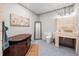 Unique bathroom with a wood style sink, a hot tub, and modern fixtures and decor at 12400 Capri N Cir, Treasure Island, FL 33706