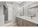 Bright bathroom with double vanity, modern fixtures, and a glass enclosed shower with stylish tile at 12400 Capri N Cir, Treasure Island, FL 33706