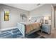 Charming bedroom with a blue bed, decorative wall art, and matching nightstands with lamps at 12400 Capri N Cir, Treasure Island, FL 33706