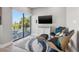 Inviting living room featuring a view of the waterfront, modern furniture, and a sleek TV at 12400 Capri N Cir, Treasure Island, FL 33706