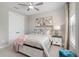 Neutral bedroom with a ceiling fan, closet, and a nightstand with stylish decor at 13167 Oldenburg Dr, Hudson, FL 34667
