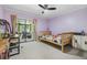 Bright bedroom with a slatted wood bed and a small desk at 1400 Tarpon Woods Blvd # E4, Palm Harbor, FL 34685
