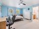 Bedroom in light blue paint shows a bed, windows, and a peek into the attached bathroom at 1400 Tarpon Woods Blvd # E4, Palm Harbor, FL 34685