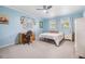 Light blue bedroom features a ceiling fan, two windows and a small desk at 1400 Tarpon Woods Blvd # E4, Palm Harbor, FL 34685