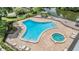 Aerial shot of the community pool and hot tub surrounded by lounge chairs and landscaping at 1400 Tarpon Woods Blvd # E4, Palm Harbor, FL 34685