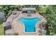 Community pool aerial view showcasing a unique shape and a relaxing hot tub at 1400 Tarpon Woods Blvd # E4, Palm Harbor, FL 34685