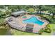 Aerial view of a community pool featuring shaded gazebos and a relaxing hot tub at 1400 Tarpon Woods Blvd # E4, Palm Harbor, FL 34685