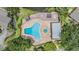 Aerial view of a sparkling community pool with lounge chairs and a sunbathing area at 1400 Tarpon Woods Blvd # E4, Palm Harbor, FL 34685