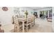 Bright dining area features a table for six, seamlessly connected to the living spaces for easy entertaining at 1400 Tarpon Woods Blvd # E4, Palm Harbor, FL 34685