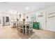 Charming dining area with seating for six, complemented by modern kitchen and bright natural light at 1400 Tarpon Woods Blvd # E4, Palm Harbor, FL 34685