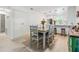 Cozy dining space with seating for six, complemented by an open kitchen and modern finishes at 1400 Tarpon Woods Blvd # E4, Palm Harbor, FL 34685