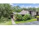 Charming condo with tropical landscaping and a private entrance, offering a welcoming curb appeal at 1400 Tarpon Woods Blvd # E4, Palm Harbor, FL 34685