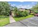 Charming condo with tropical landscaping and inviting entrance, offering a serene and well-maintained exterior at 1400 Tarpon Woods Blvd # E4, Palm Harbor, FL 34685