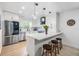 Bright kitchen features white cabinets, stainless steel appliances, and a countertop island with seating at 1400 Tarpon Woods Blvd # E4, Palm Harbor, FL 34685