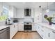 Well-lit kitchen with white cabinetry, stainless steel appliances, and quartz countertops at 1400 Tarpon Woods Blvd # E4, Palm Harbor, FL 34685