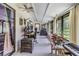 Spacious sunroom filled with natural light, showcasing a versatile space for work or relaxation, and backyard views at 1400 Tarpon Woods Blvd # E4, Palm Harbor, FL 34685