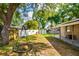 Spacious backyard featuring mature trees, storage shed, and an outdoor swing, ideal for Gathering fun at 1403 W Pradera Ave, Tampa, FL 33612