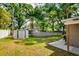 Green backyard featuring an above ground pool, storage shed, and a trampoline at 1403 W Pradera Ave, Tampa, FL 33612